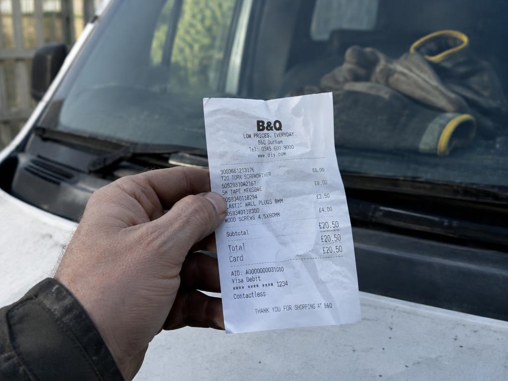 A receipt held up against a windscreen